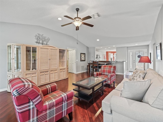 living room with hardwood / wood-style flooring, lofted ceiling, a textured ceiling, and ceiling fan