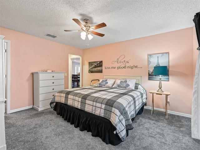 carpeted bedroom with ceiling fan and a textured ceiling