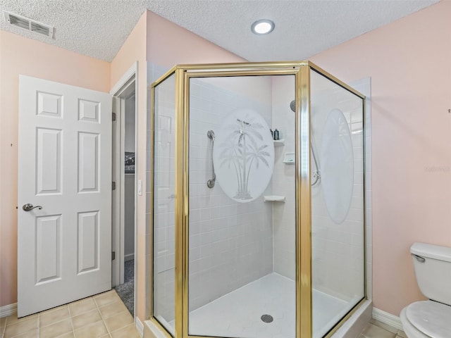 bathroom featuring a shower with door, tile patterned floors, a textured ceiling, and toilet