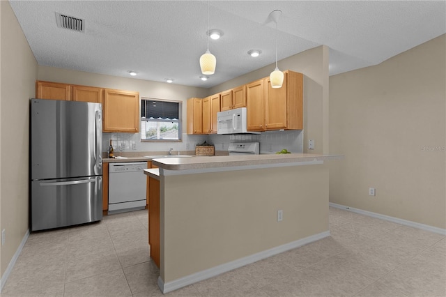 kitchen featuring light brown cabinetry, tasteful backsplash, sink, hanging light fixtures, and white appliances