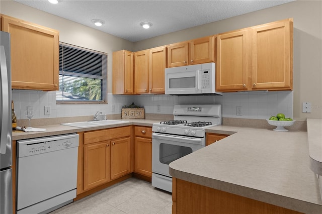 kitchen with sink, white appliances, backsplash, a textured ceiling, and light tile patterned flooring