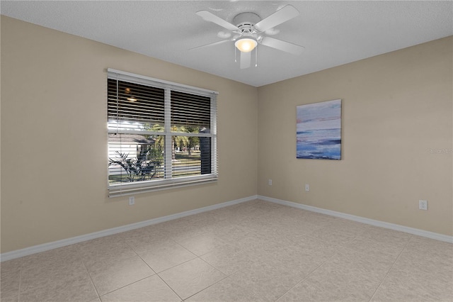 unfurnished room featuring light tile patterned flooring, ceiling fan, and a textured ceiling