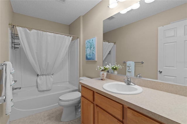 full bathroom featuring vanity, a textured ceiling, tile patterned floors, toilet, and shower / bath combo with shower curtain