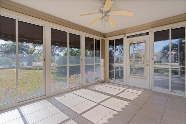 unfurnished sunroom featuring ceiling fan