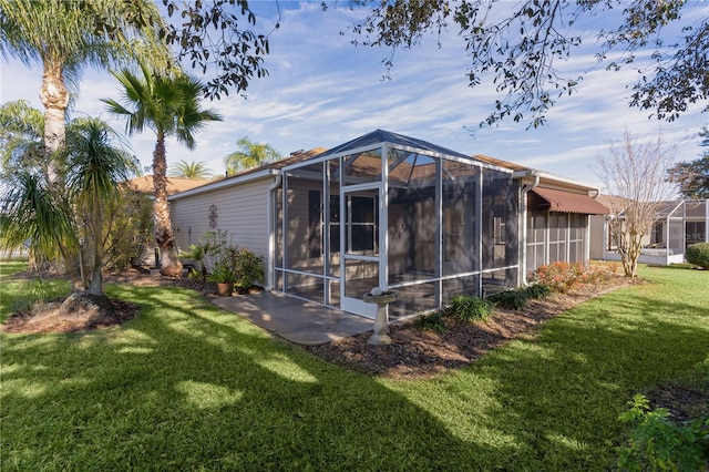 rear view of property featuring a lawn