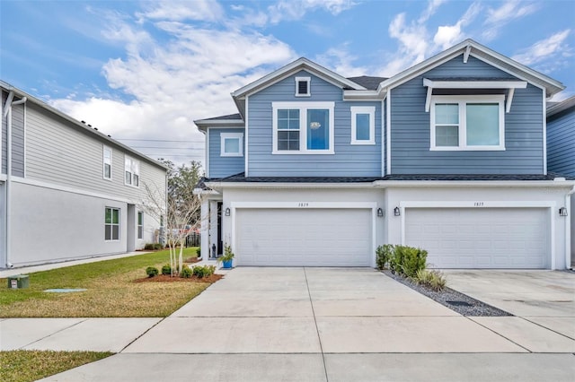 view of front of home featuring concrete driveway, a garage, and a front yard