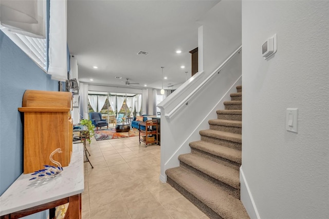 staircase featuring tile patterned floors, visible vents, and recessed lighting