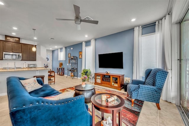 living area with recessed lighting, visible vents, ceiling fan, and light tile patterned floors