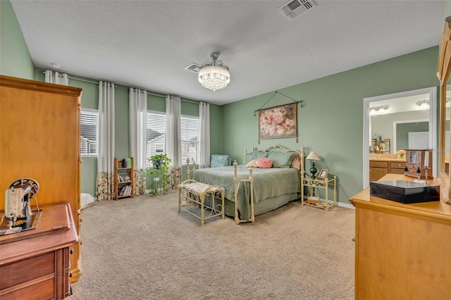 carpeted bedroom with visible vents and a textured ceiling