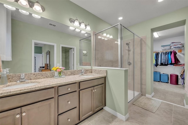 bathroom featuring a sink, visible vents, and a shower stall