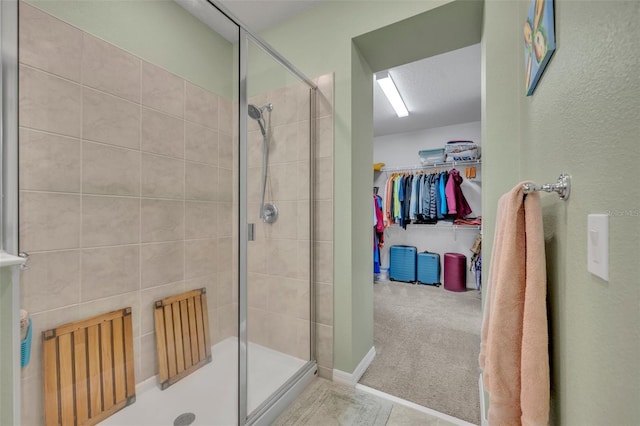 full bath featuring a spacious closet and a stall shower