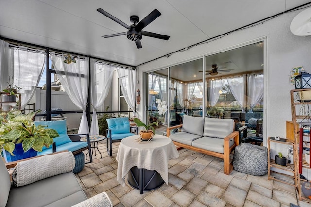 sunroom / solarium featuring a ceiling fan and a healthy amount of sunlight