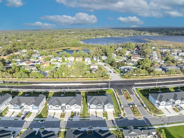 bird's eye view featuring a residential view, a water view, and a view of trees