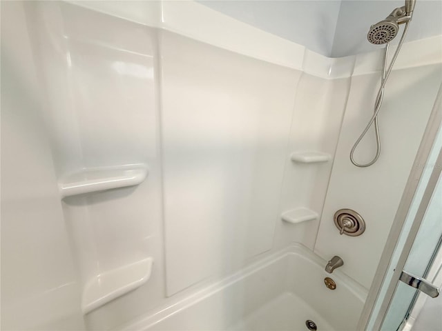 bathroom with shower / washtub combination