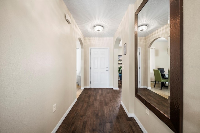 corridor with hardwood / wood-style flooring