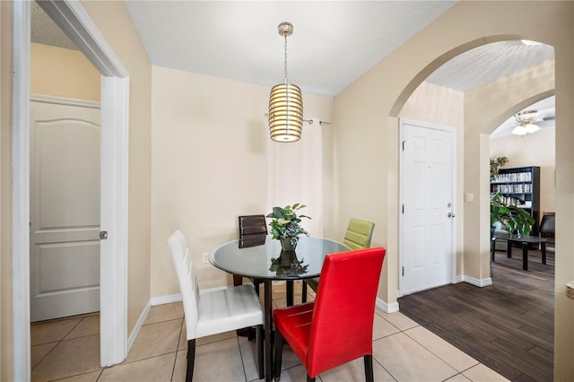 dining space with light tile patterned floors and a textured ceiling