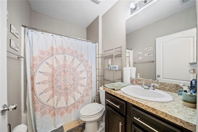 bathroom with a shower with curtain, vanity, toilet, and a textured ceiling