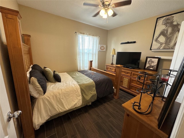 bedroom with a ceiling fan, a textured ceiling, and wood tiled floor