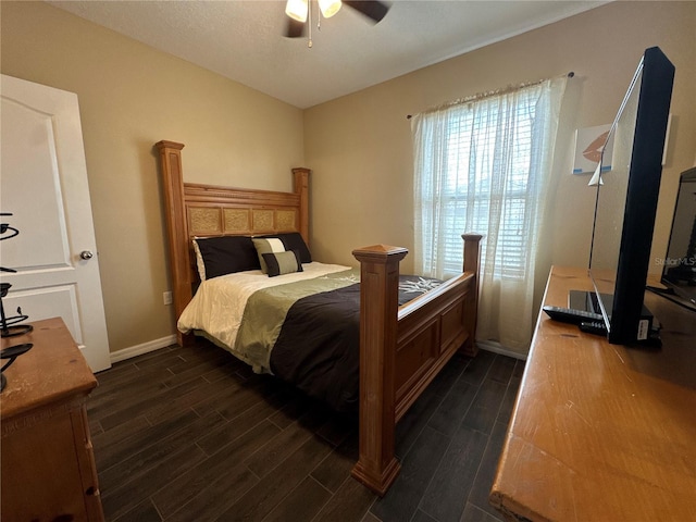 bedroom featuring a ceiling fan, baseboards, and wood finish floors