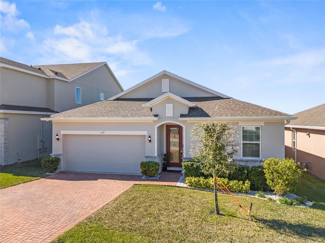 view of front of house with a garage and a front lawn