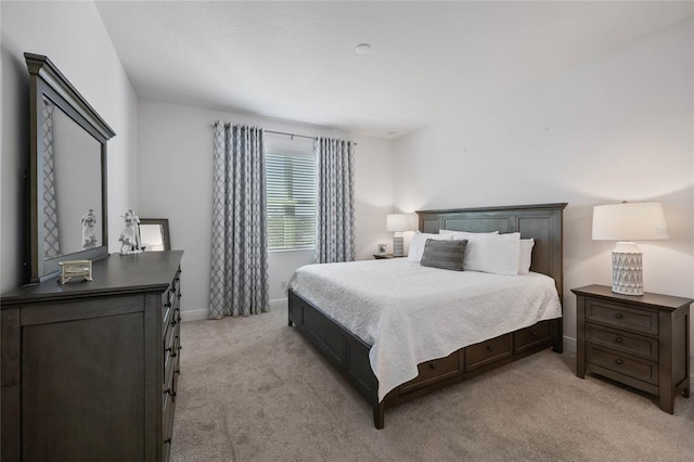 bedroom featuring light colored carpet