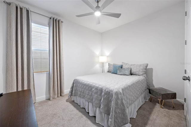 bedroom featuring light colored carpet and ceiling fan