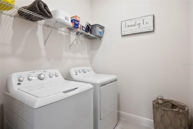 washroom with independent washer and dryer and tile patterned flooring