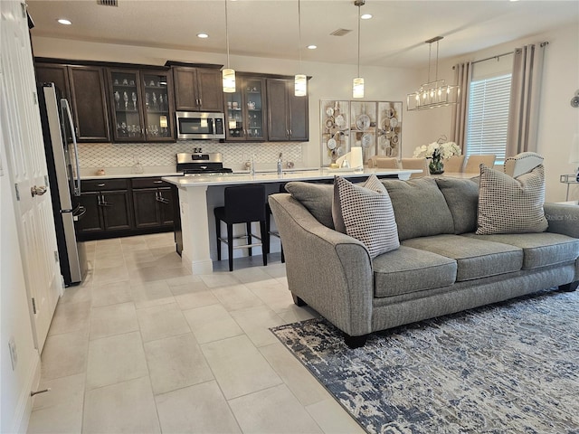 living room featuring sink and light tile patterned floors