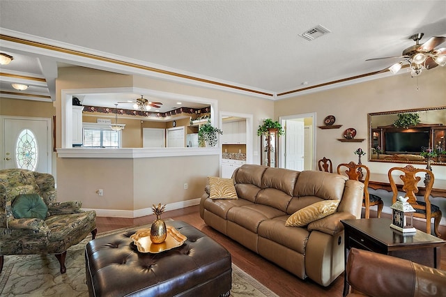 living room featuring ceiling fan, wood-type flooring, and a textured ceiling