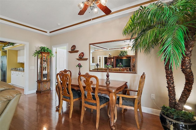 dining room with dark hardwood / wood-style flooring, ornamental molding, a raised ceiling, and ceiling fan