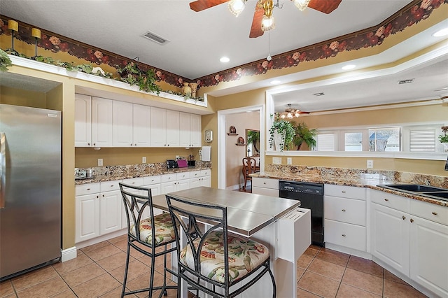 kitchen featuring white cabinets, sink, stainless steel refrigerator, and dishwasher