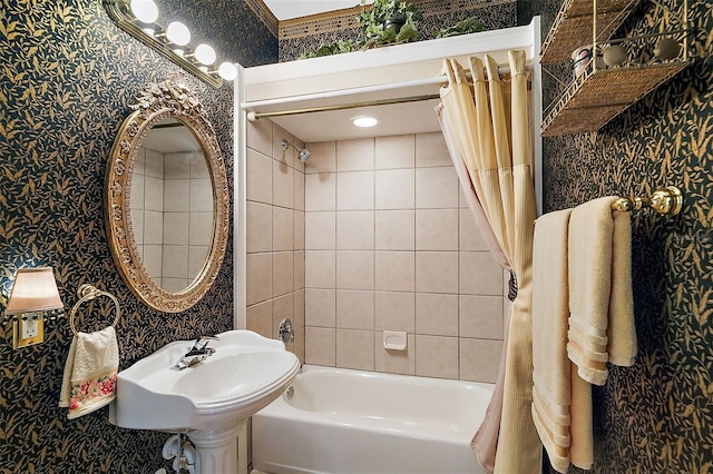 bathroom featuring sink and shower / bath combination with curtain