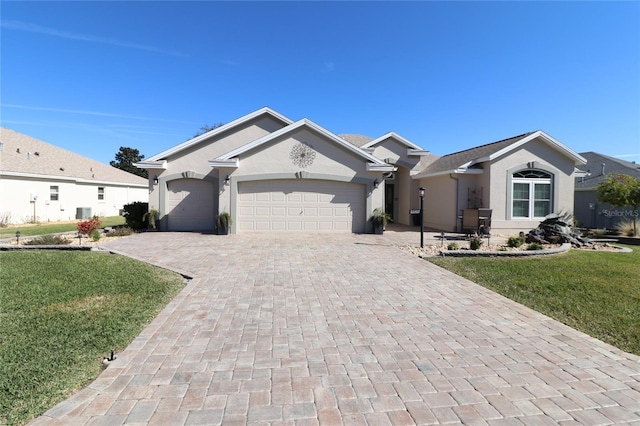 single story home with a garage and a front lawn