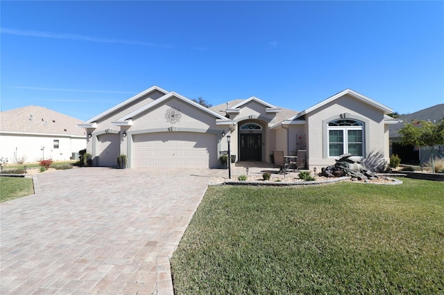 ranch-style house with a garage and a front lawn