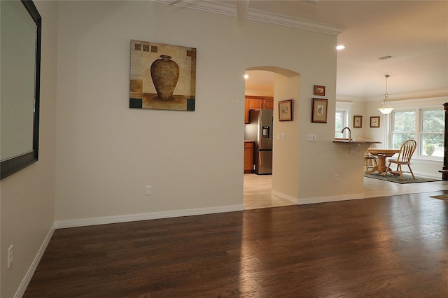 spare room featuring ornamental molding and dark hardwood / wood-style floors