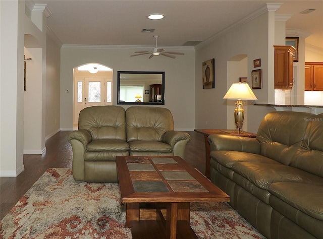 living room featuring dark hardwood / wood-style flooring, ornamental molding, and ceiling fan