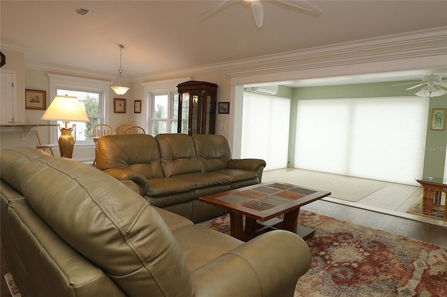 living room featuring ornamental molding, a wall mounted AC, ceiling fan, and light hardwood / wood-style floors