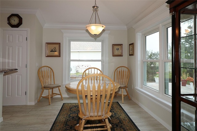 dining area with ornamental molding and a wealth of natural light