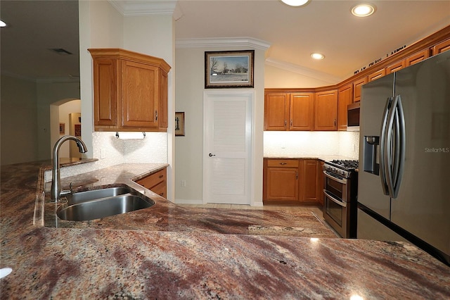 kitchen with sink, dark stone countertops, backsplash, stainless steel appliances, and crown molding