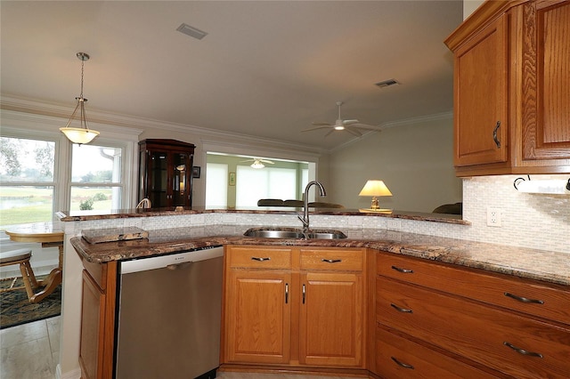 kitchen with vaulted ceiling, dishwasher, sink, light stone counters, and kitchen peninsula