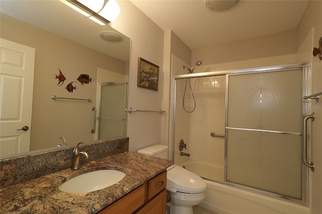 full bathroom with vanity, shower / bath combination with glass door, and toilet