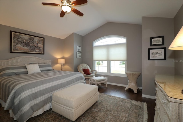 bedroom featuring dark hardwood / wood-style flooring, vaulted ceiling, and ceiling fan