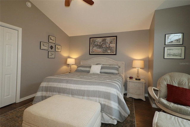 bedroom featuring ceiling fan, dark hardwood / wood-style flooring, vaulted ceiling, and a closet