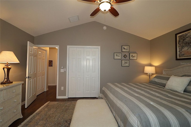 bedroom featuring dark wood-type flooring, ceiling fan, vaulted ceiling, and a closet