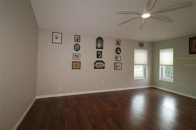 spare room with ceiling fan and dark hardwood / wood-style flooring