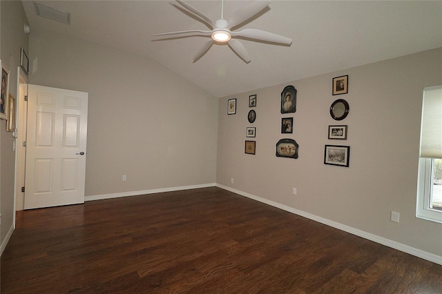 spare room with dark hardwood / wood-style flooring, lofted ceiling, and ceiling fan