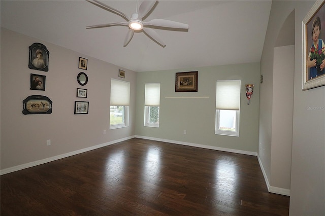 spare room with dark hardwood / wood-style flooring and ceiling fan