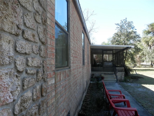 view of side of home featuring a sunroom