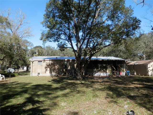 rear view of house with a yard