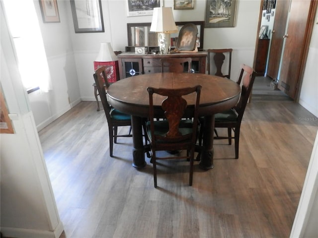 dining space with hardwood / wood-style flooring